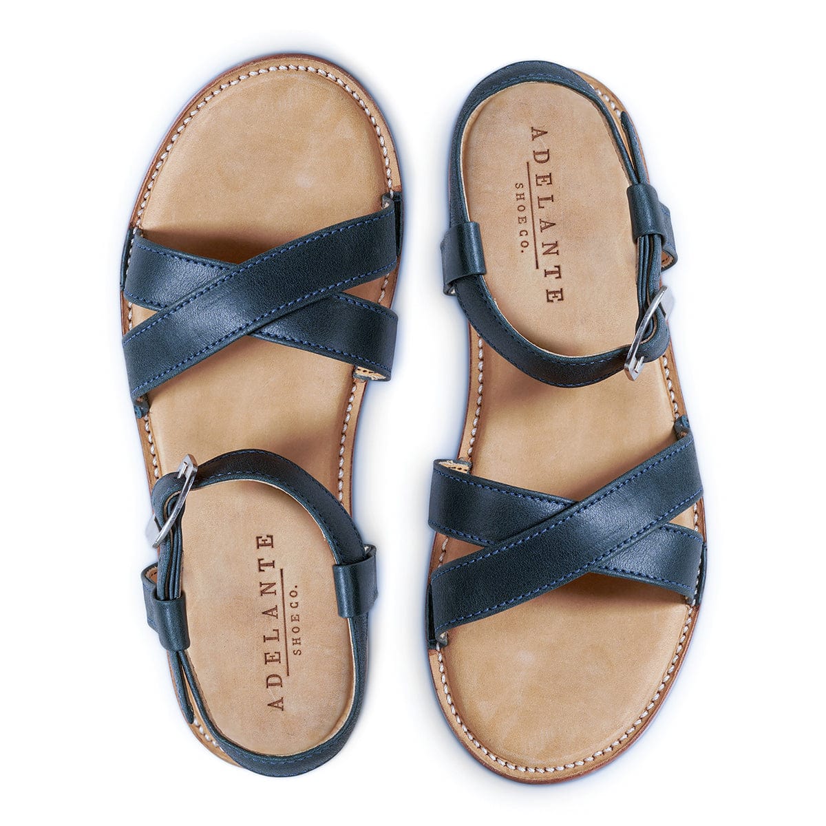 Adelante women's dark leather sandals with crossed straps, adjustable ankle buckles, cushioned footbeds, and handcrafted stitching in wide widths