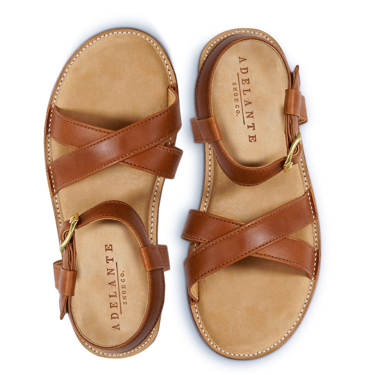 Brown leather women's sandals with crossover straps and adjustable ankle buckles, handcrafted by Adelante in sizes 4 to 8.5 and narrow to extra wide widths