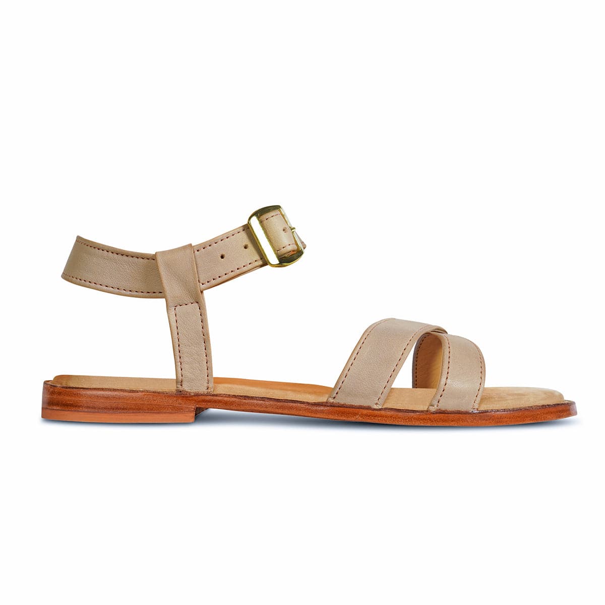 Women's tan leather sandal with adjustable ankle strap, buckle, cushioned footbed, and flat wooden sole by Adelante Made-To-Order