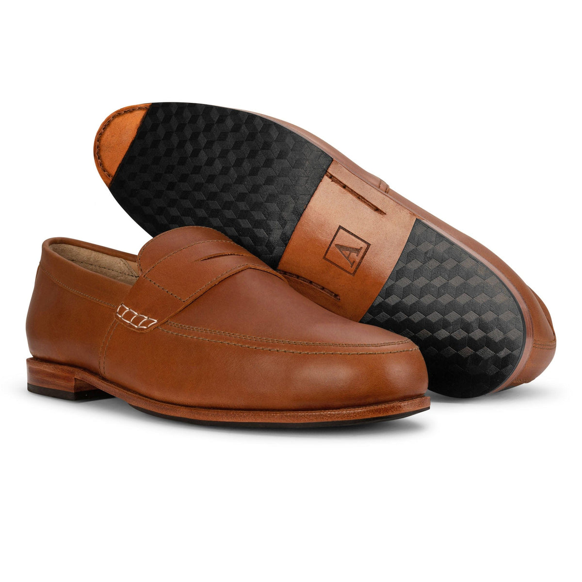 Adelante handcrafted brown leather men's loafer with moc toe, penny strap, and textured rubber sole shown in a polished product display
