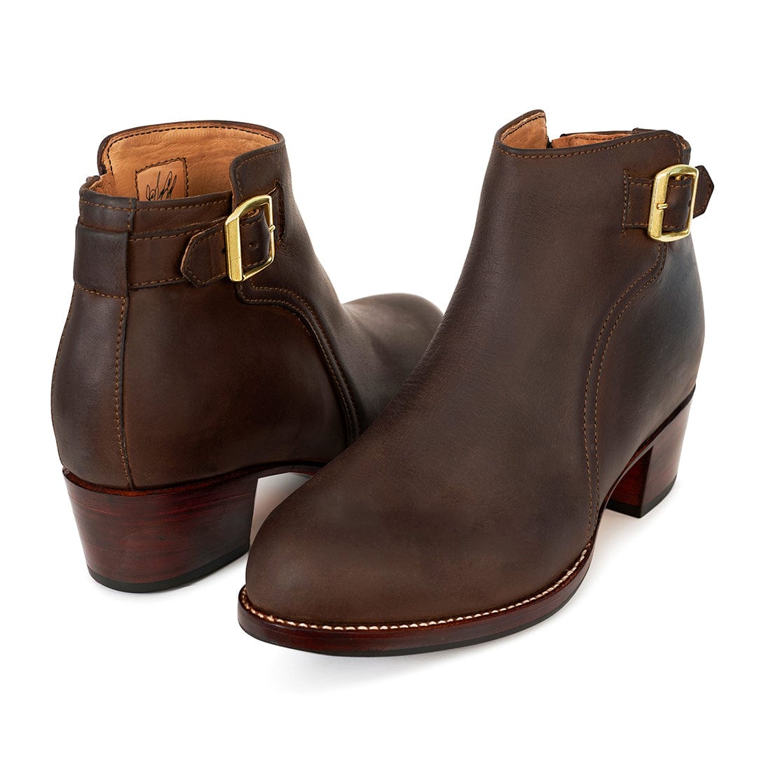 Brown women's buckle booties with adjustable straps, side zippers, and block heels, handcrafted in Guatemala and available in wide widths