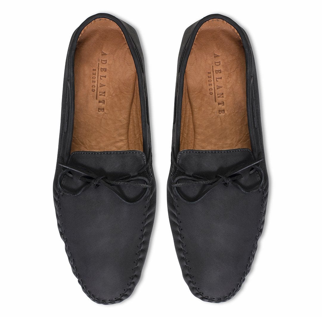 Top-down view of a pair of men's 4E-wide black leather moccasins, built to order, even in size 15.5