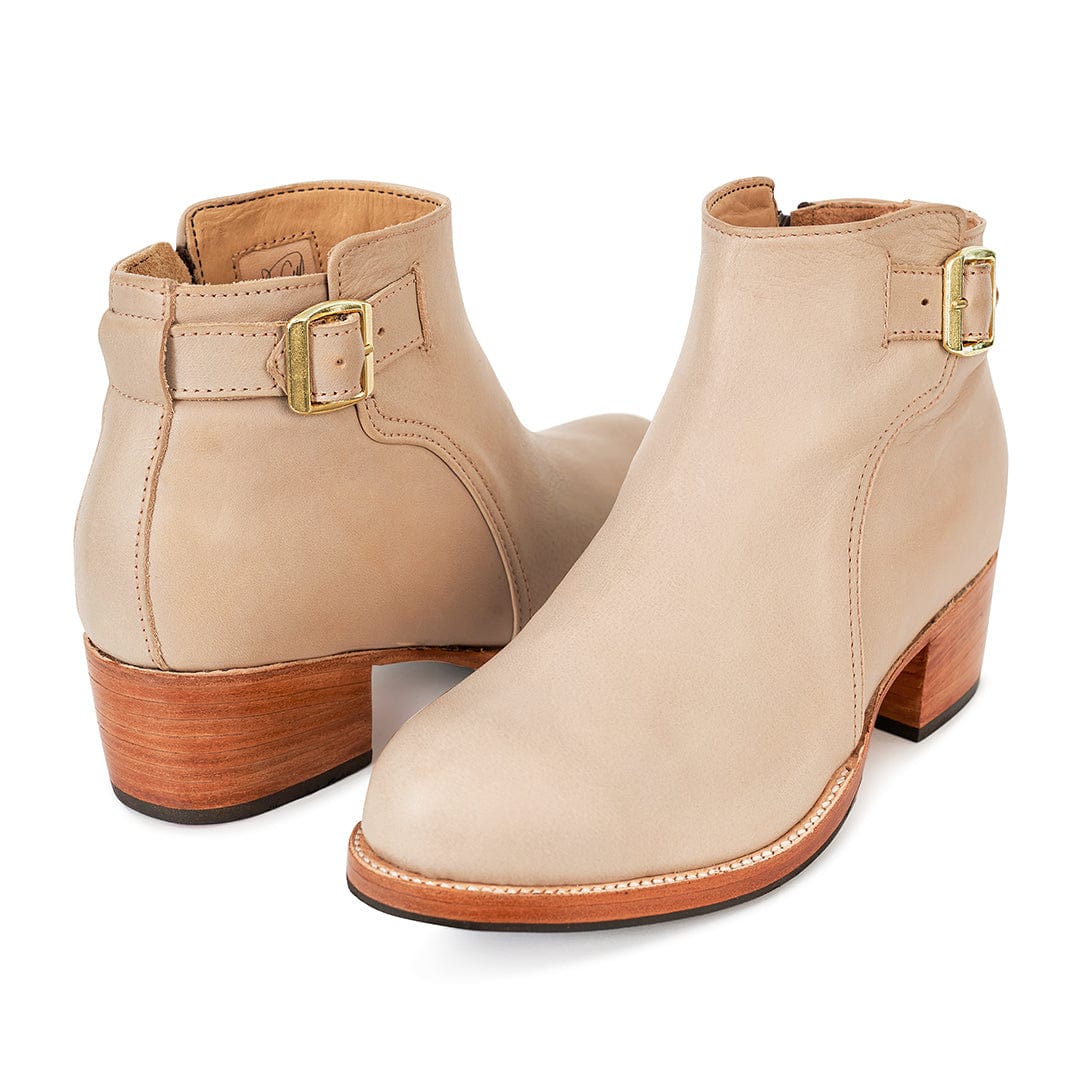 Women's beige leather buckle booties with adjustable straps, inside zippers, stacked block heels, and handcrafted welted soles in wide widths