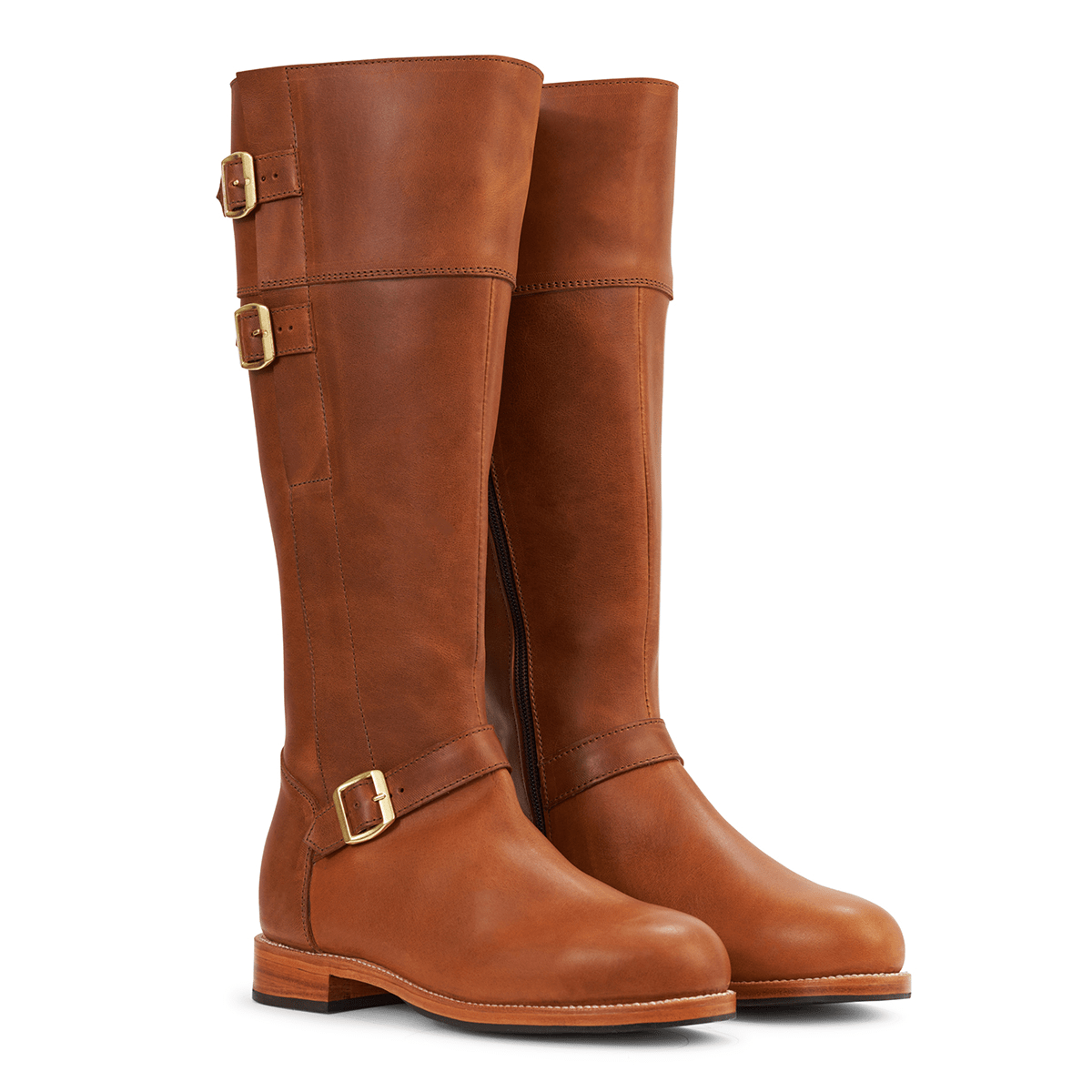 Women's brown leather riding boots with brass buckle straps, wraparound detailing, side zippers, and a wide calf fit.