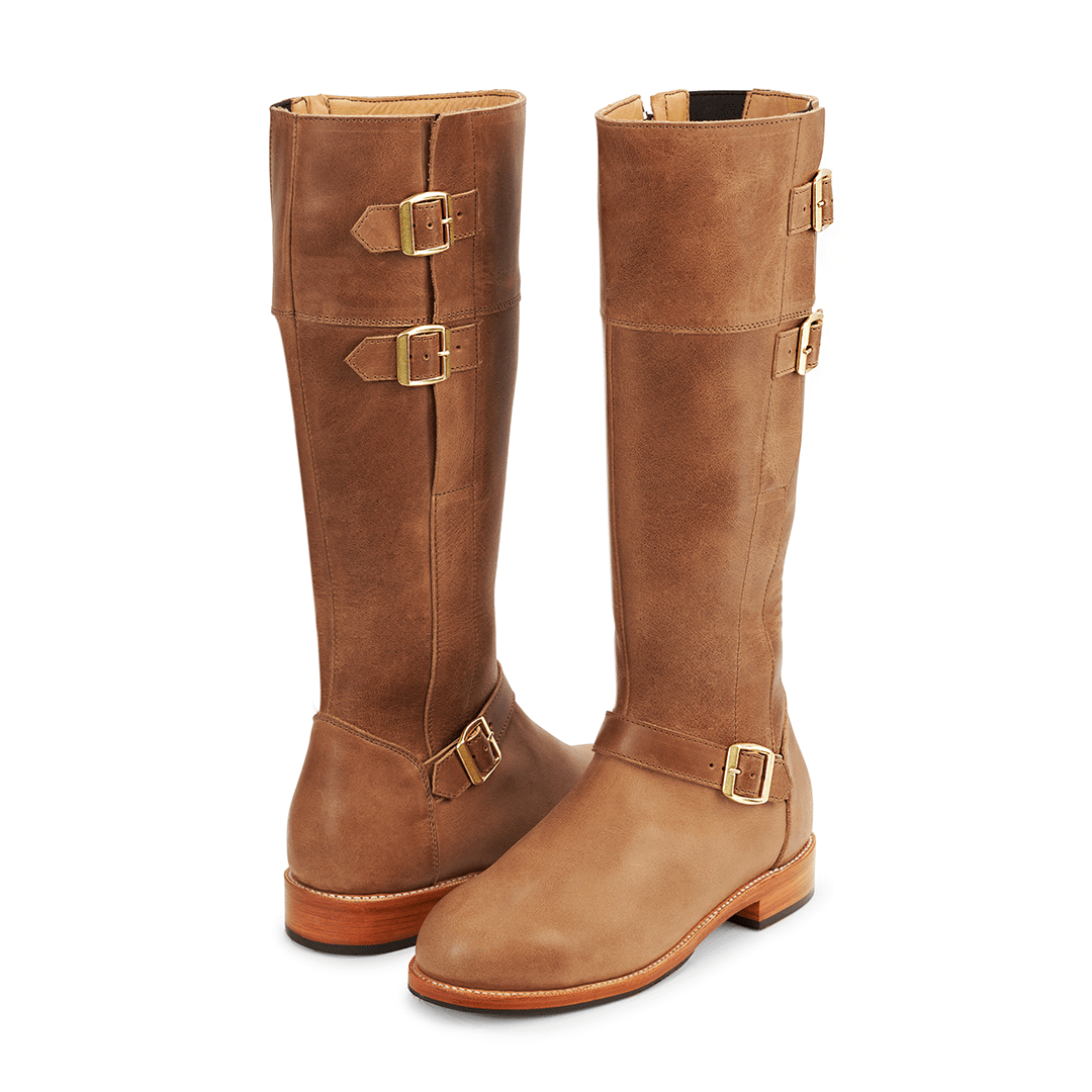 Brown women's tall riding boots with brass buckle straps and wide calf fit, handcrafted and made to order by Adelante
