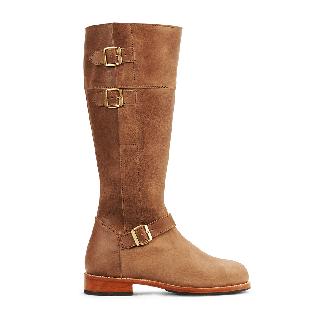 Brown women's tall riding boot with three brass buckles and wraparound leather straps handcrafted in wide calf sizes by Adelante