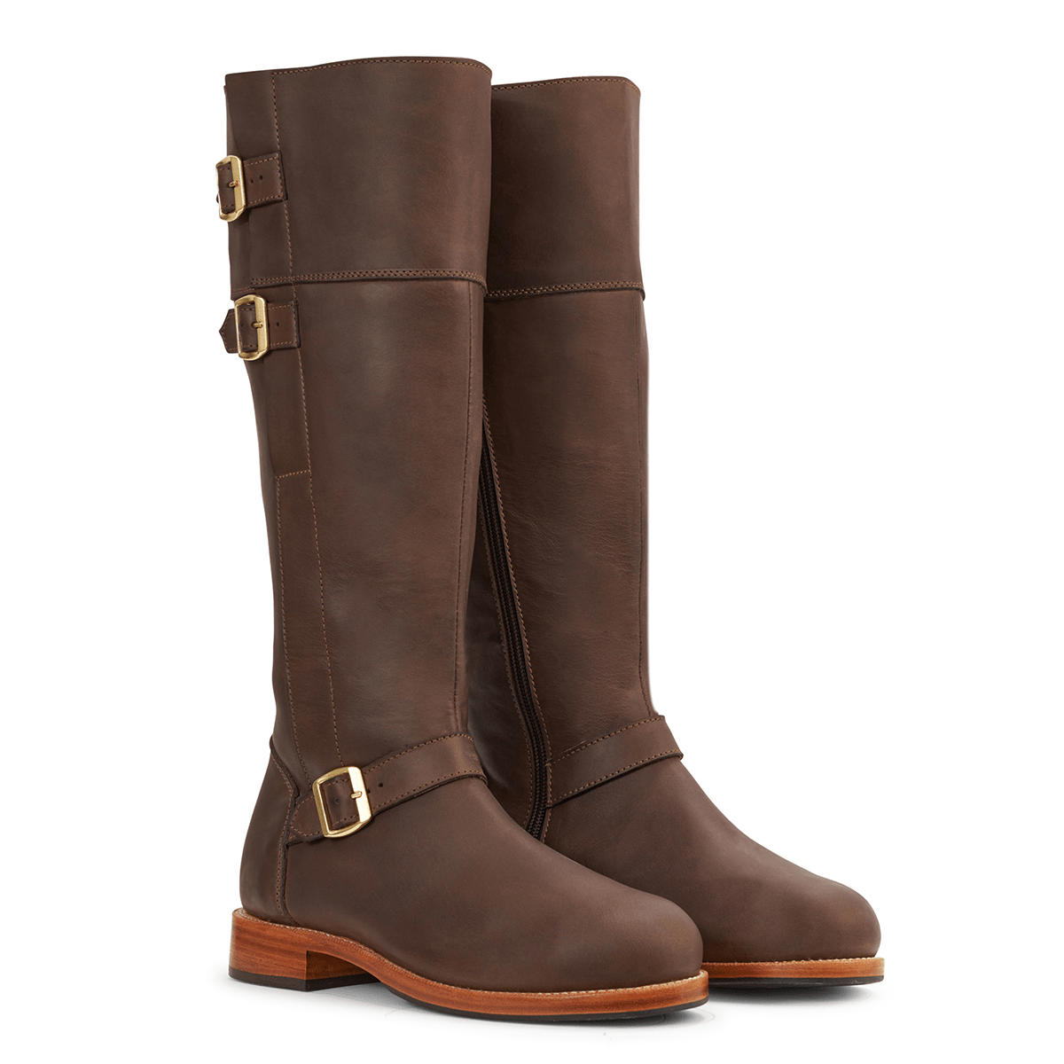 Adelante brown leather womens tall riding boots with brass buckles, wraparound straps, side zippers, and wide calf sizing
