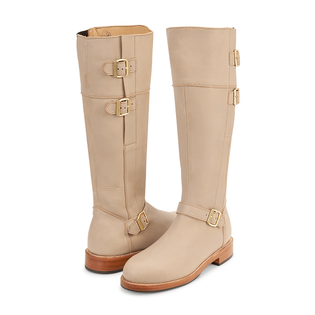 Women's beige tall riding boots with brass buckles, handcrafted leather and wide calf fit by Adelante Made To Order