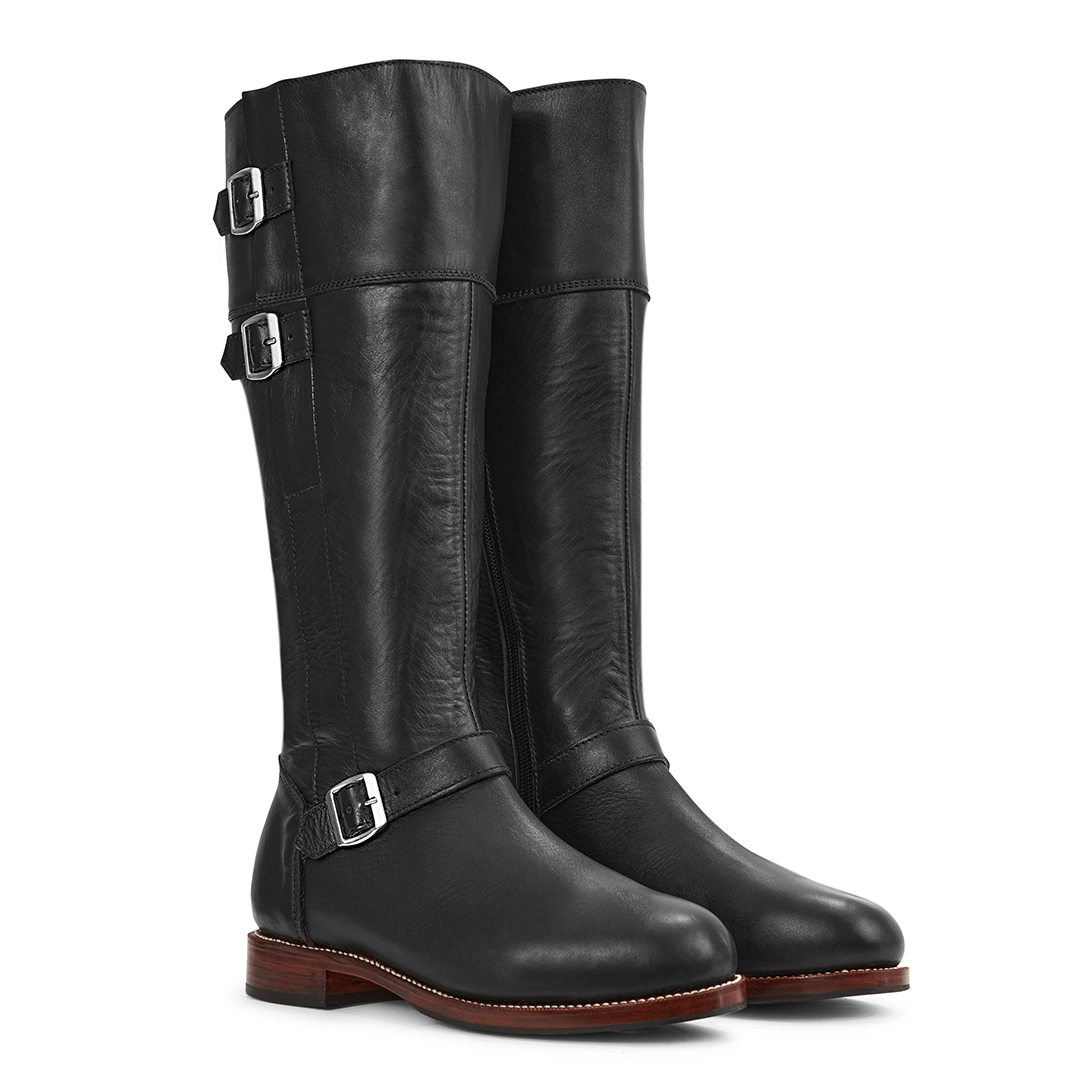 Black women's tall riding boots with buckle straps, leather uppers, and low stacked heels, available in wide calf widths from Adelante Made To Order