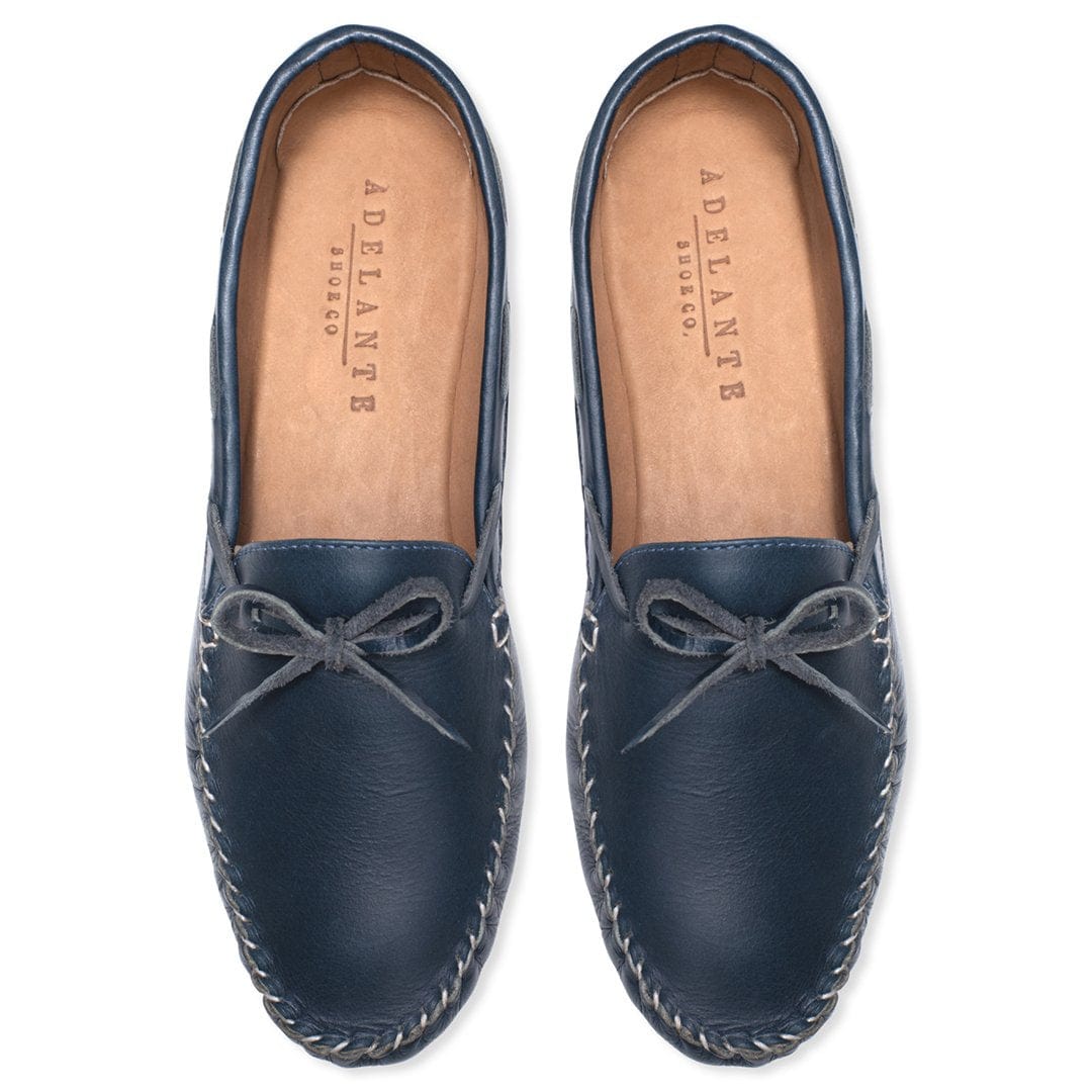 Navy leather moccasins with bow detail and hand stitched soles for women, handcrafted by Adelante Shoes