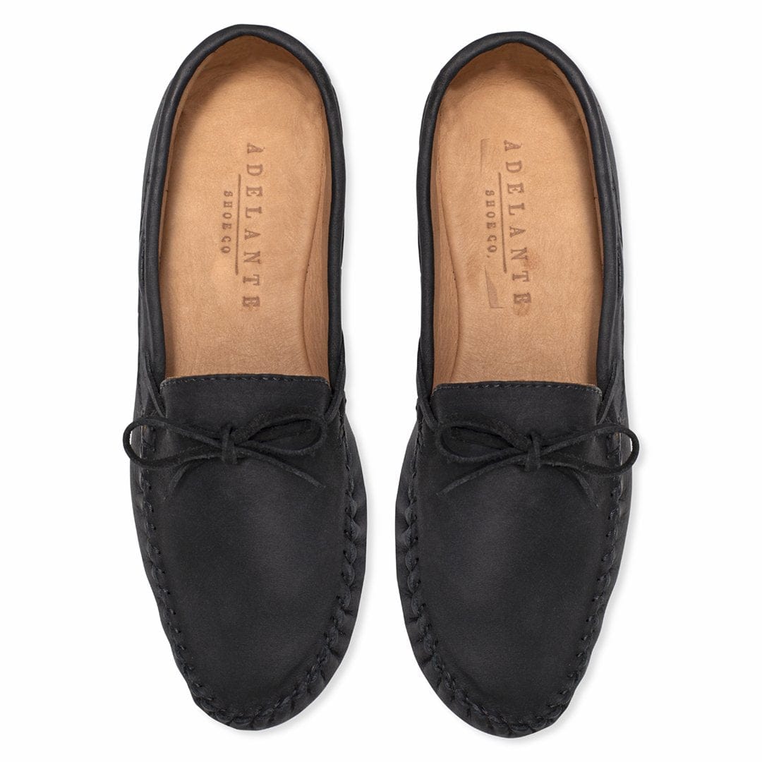 Black leather womens moccasins with bow ties and hand stitched soles handcrafted by Adelante Made To Order