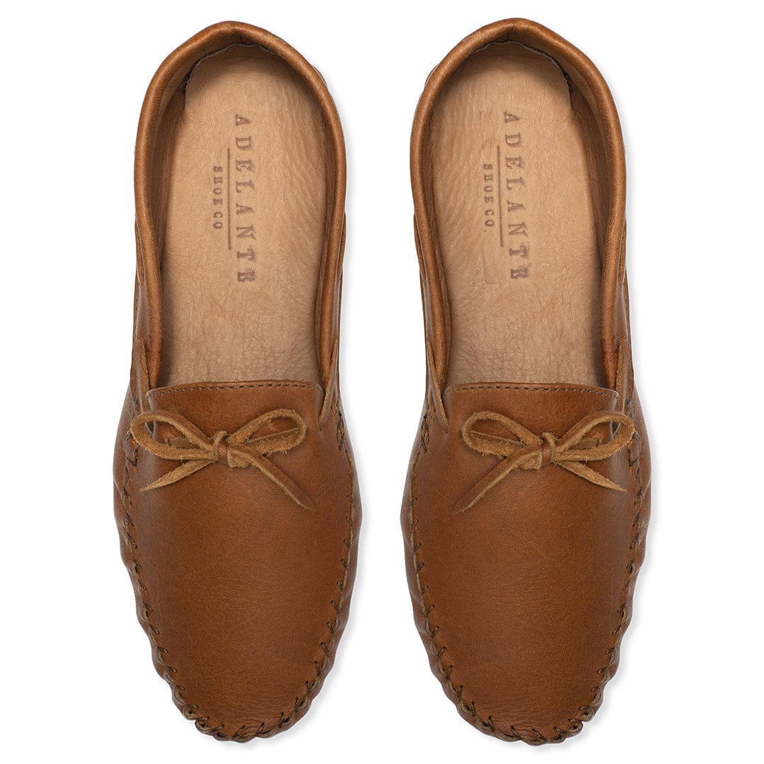 Brown leather womens moccasins with tied bows and hand stitched soles, handcrafted by Adelante in wide width options
