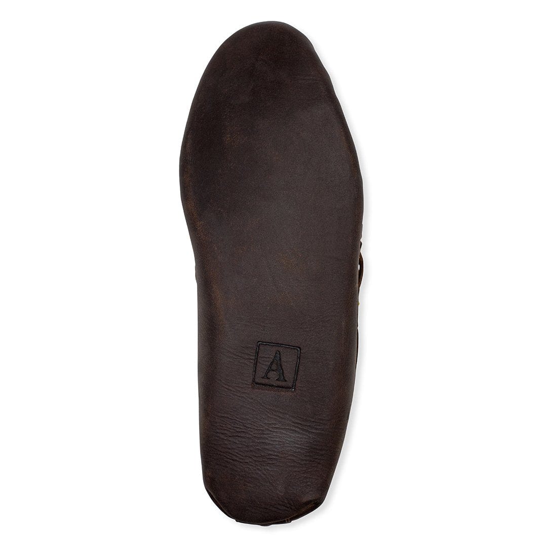 Dark brown leather sole of a handcrafted women's moccasin with Adelante logo