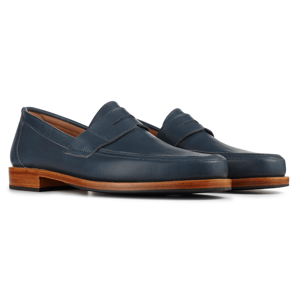 Adelante mens navy penny loafers with classic penny straps, sleek toes, and layered wood tone soles