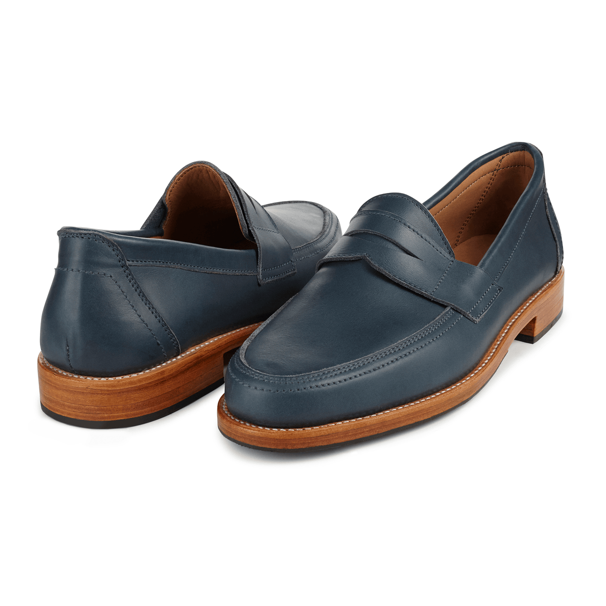 Navy men's penny loafers in handcrafted leather with classic penny bridges and wood tone soles, available in wide widths from Adelante Made To Order