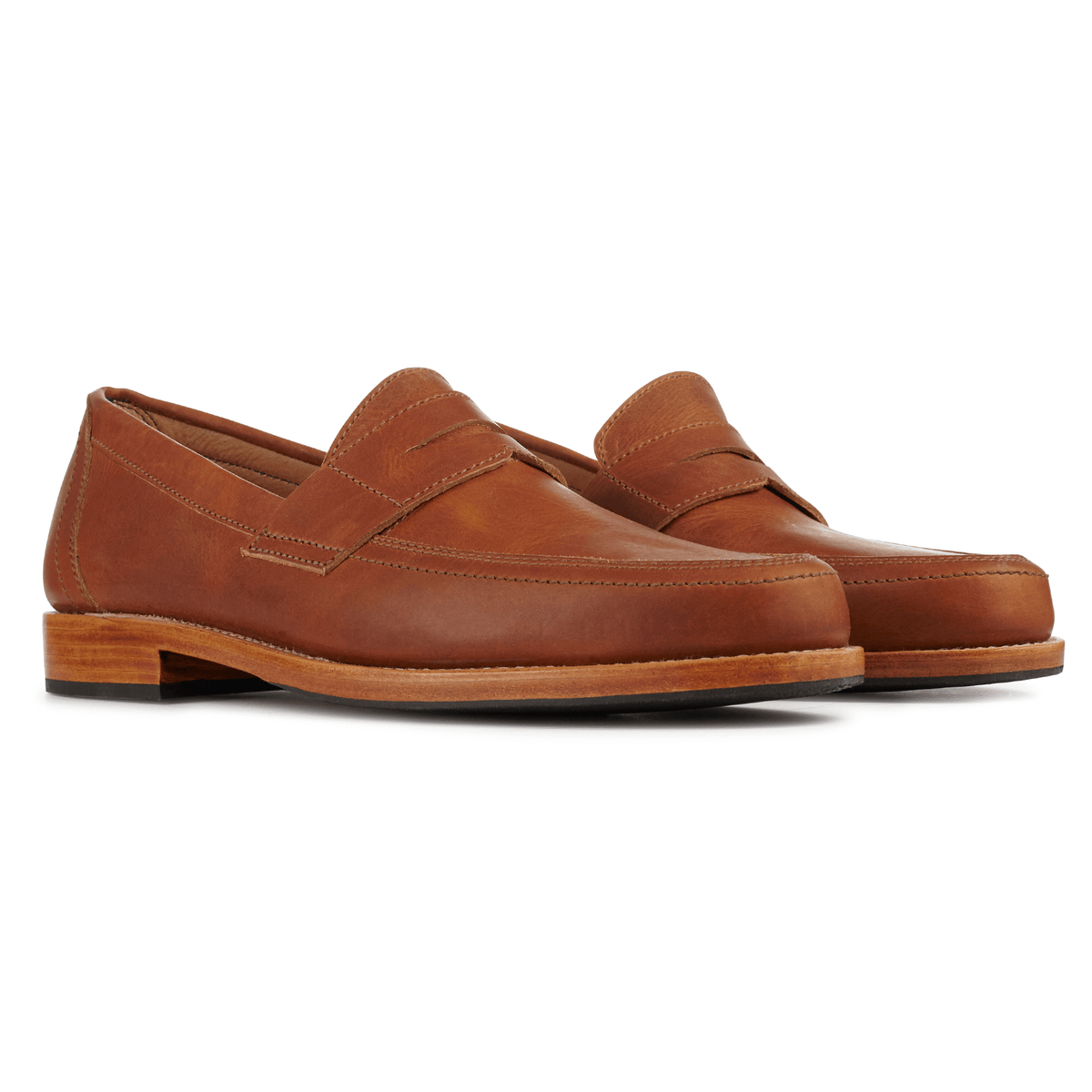 Brown men's penny loafers with classic penny bridges and stitched leather uppers, handcrafted by Adelante Made-To-Order
