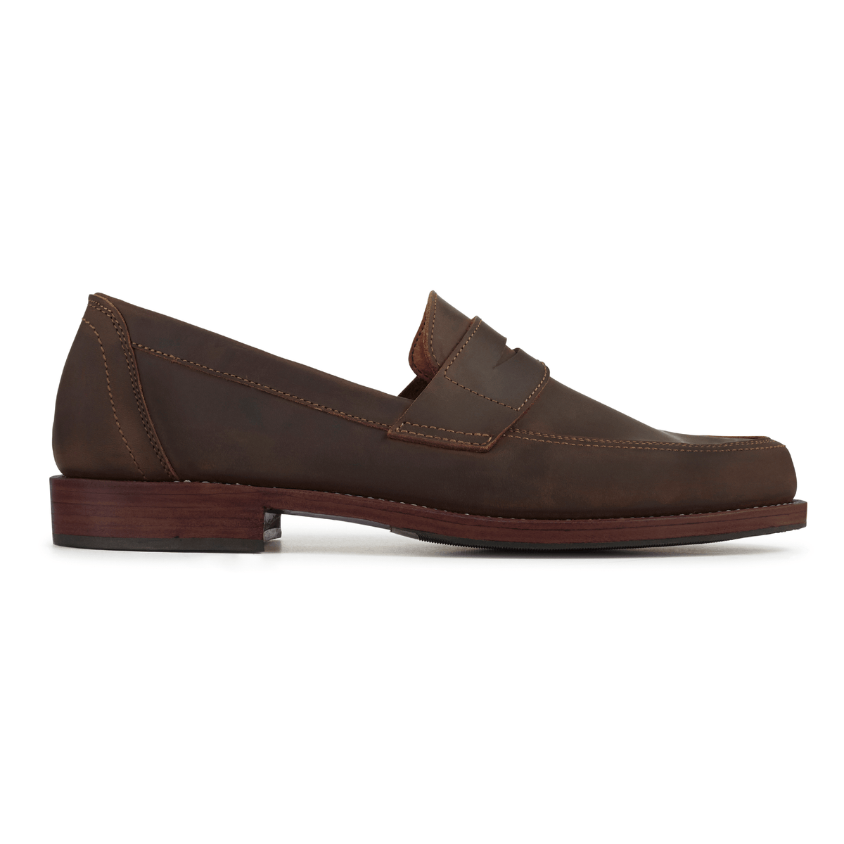 Brown men's penny loafer with a classic penny bridge, sleek toe, and stacked wood tone heel on a white background