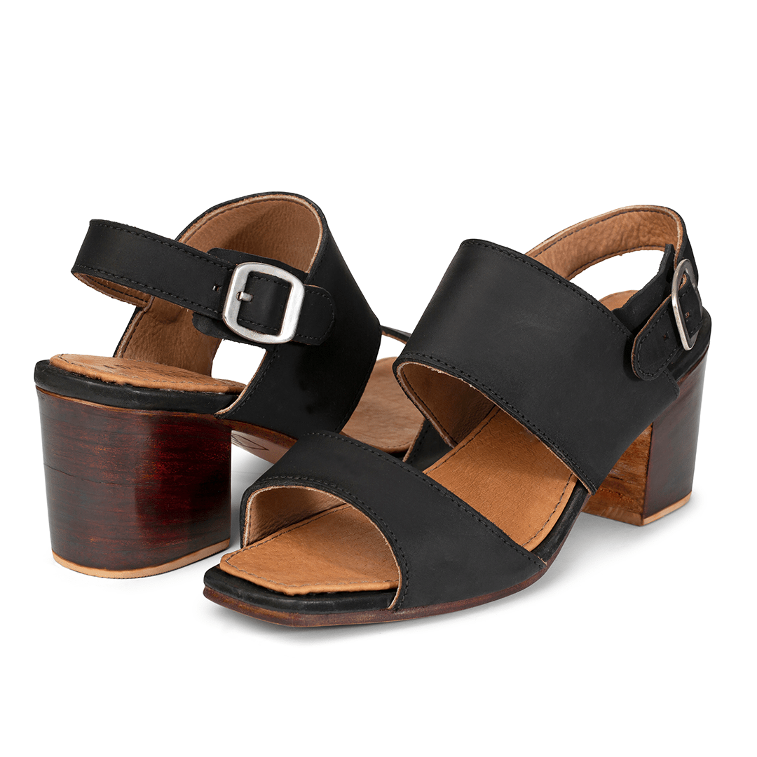Pair of women's EE wide black leather heeled sandals, shown from the front at an angle, made by hand in Guatemala – The Serena