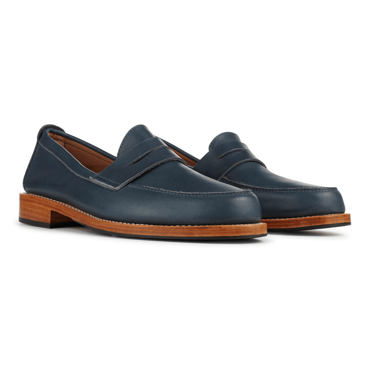 Women's navy leather penny loafers with brown soles, handcrafted by Adelante Made-To-Order
