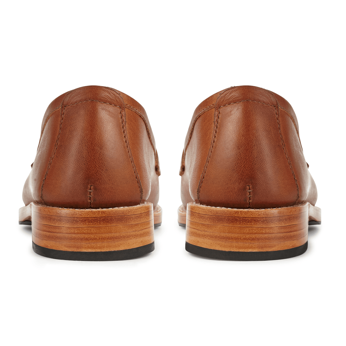 Brown leather womens penny loafers shown from the back with stacked heels and black rubber soles
