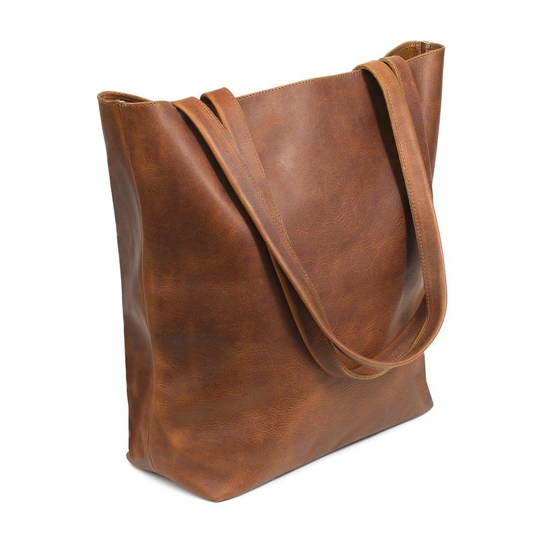 Light brown leather tote bag, shown at an angle, full-grain leather, made by hand
