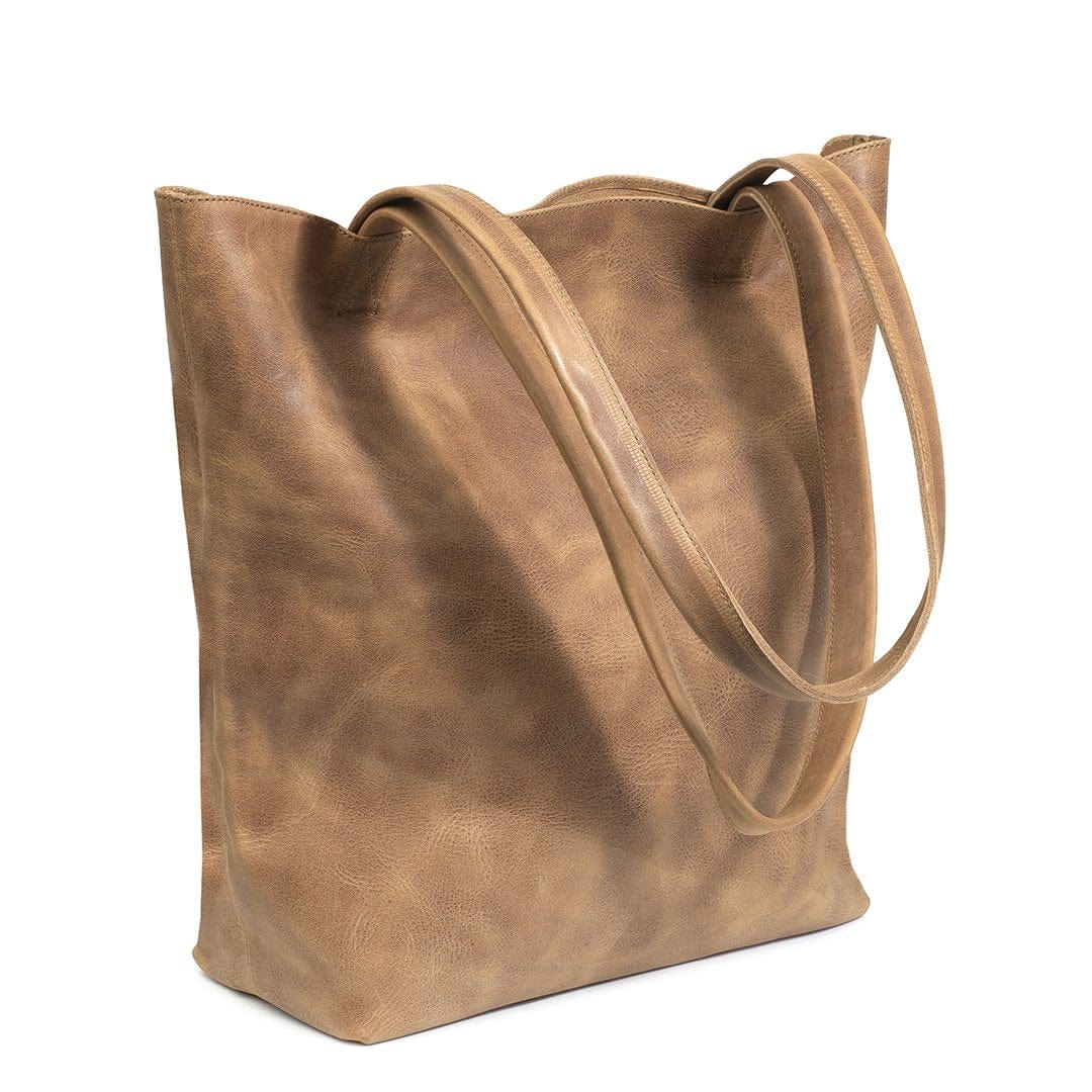 Tan leather tote bag, shown at an angle, customization available