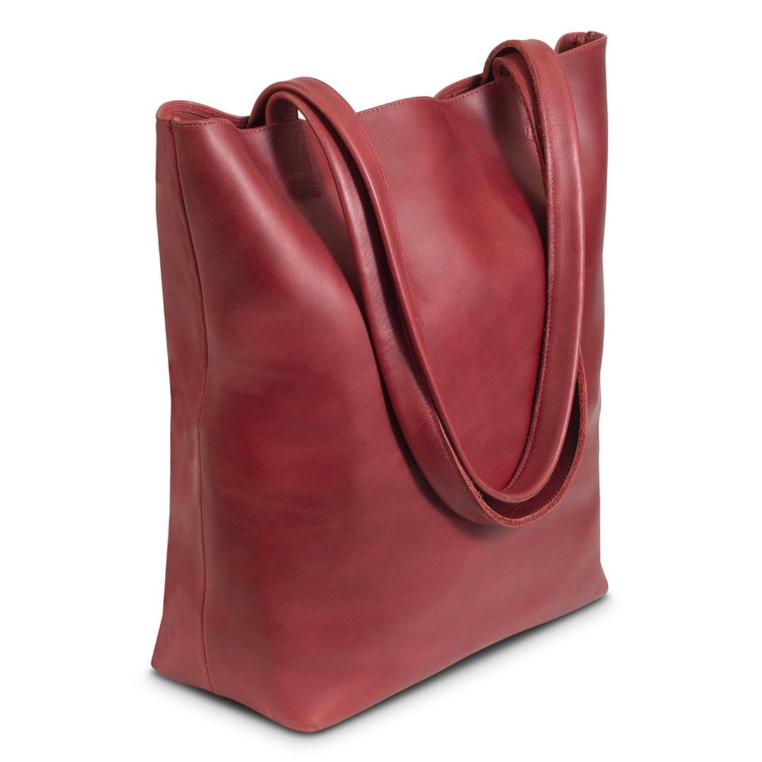 Red leather tote bag, shown at an angle, customization available
